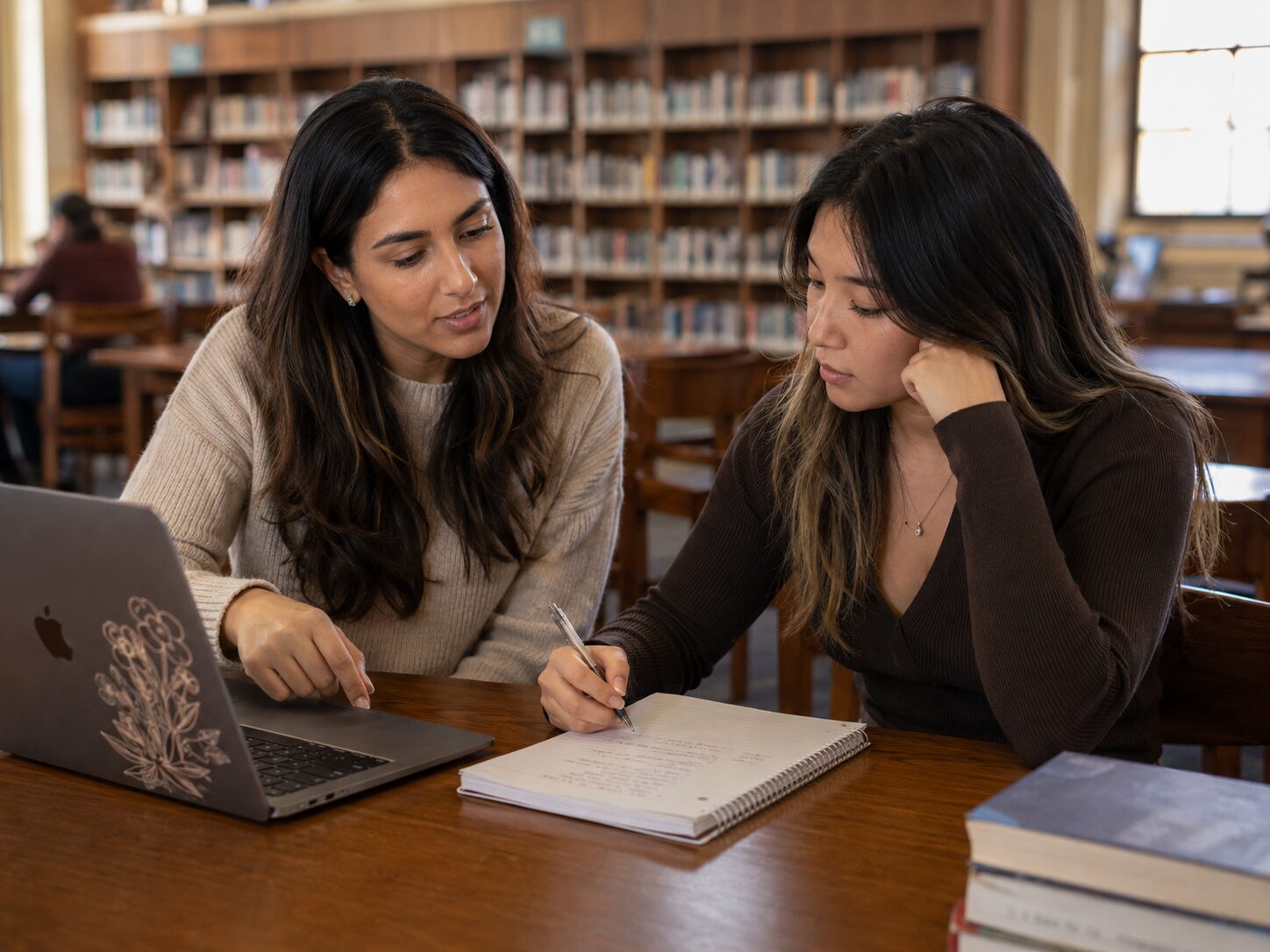 ChatGPT Image Jul 19, 2026 at 01_11_13 PM Mentor reviewing a planner with a young adult student during an academic coaching session in a library
