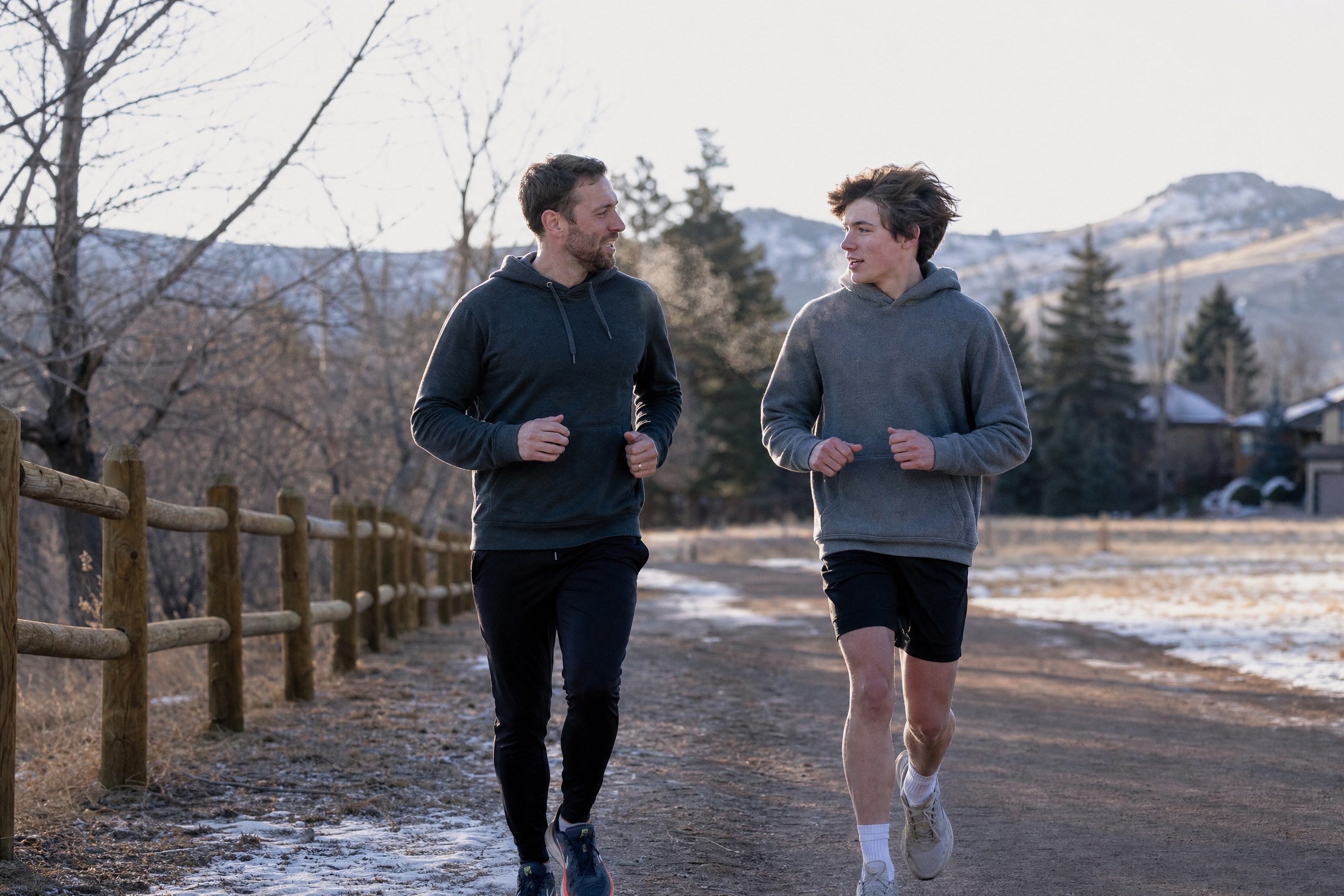 physical-health-morning-run A mentor and a teenage boy jogging side by side in early morning light
